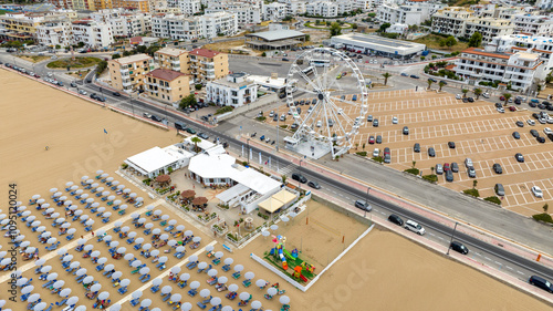 Aerial view of the Ferris wheel on the seafront in Vieste, Puglia, Italy. In front of the tourist attraction are the beaches.