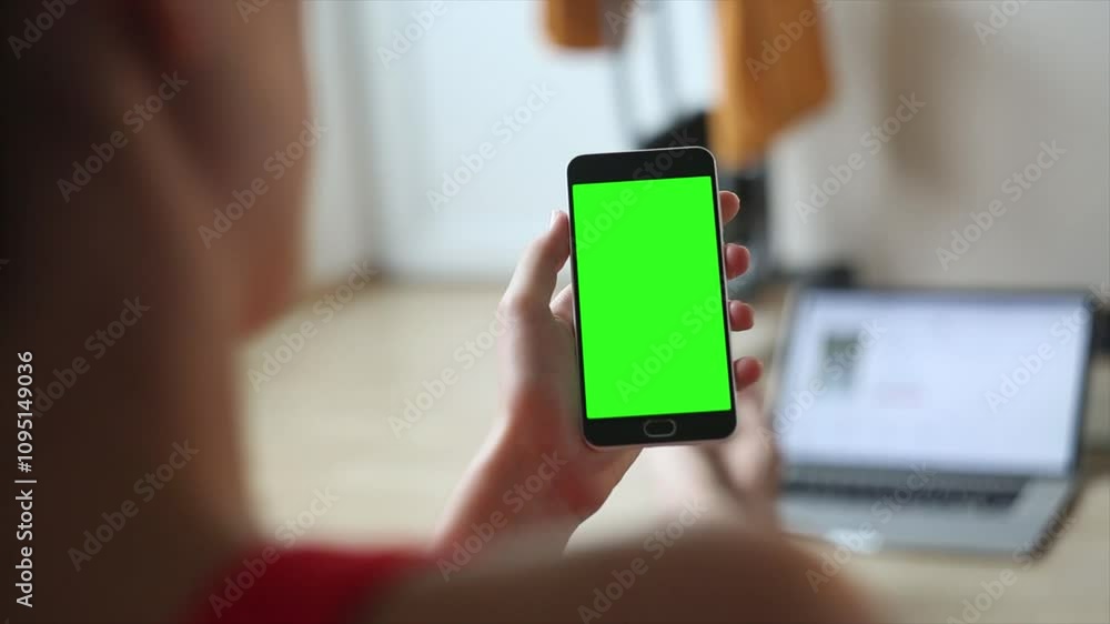 person using smartphone, Close up hands holding phone with vertical green screen stand near window. On background street person using smartphone, Close up hands holding phone with vertical green screen stand near window. On background street