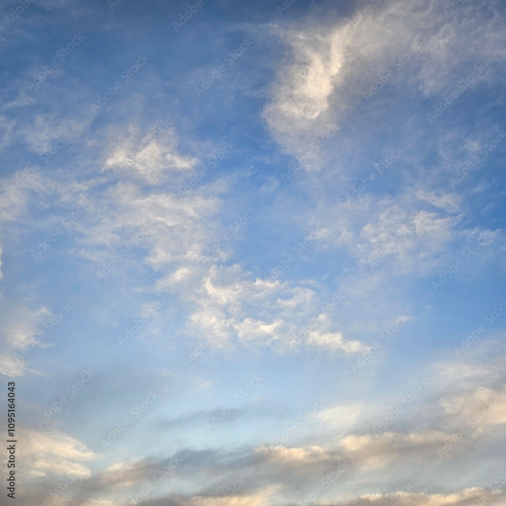 Expansive blue sky dotted with wispy white clouds. Expansive blue sky dotted with wispy white clouds.