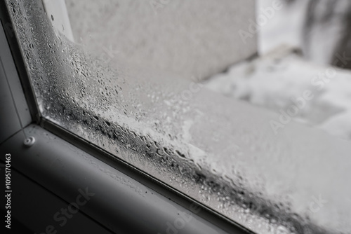 Tableau sur toile Water drops condensed at cold window during winter season, closeup detail