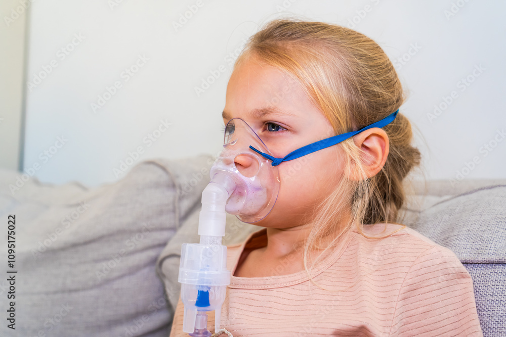 Young girl using a nebulizer at home for respiratory treatment during a calm afternoon