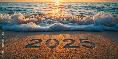 The year 2025 is written on sand as the sunset illuminates the ocean, reflecting the beauty of new horizons and the passage of time photo