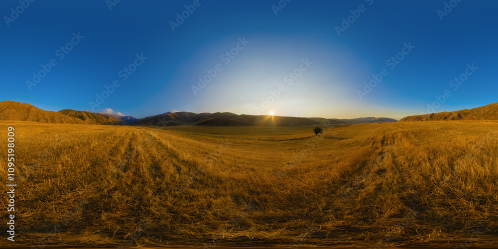 Full Spherical panorama of straw moved agricultural field surrounded with foothills at autumn sunset with blue sky in equirectangular projection Full Spherical panorama of straw moved agricultural field surrounded with foothills at autumn sunset with blue sky in equirectangular projection