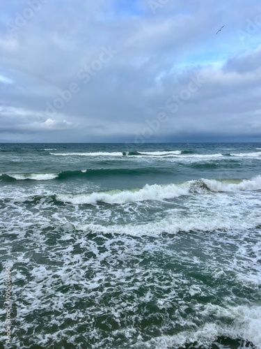 Cloudy seascape, seashore waves, natural sea horizon, cloudy sky