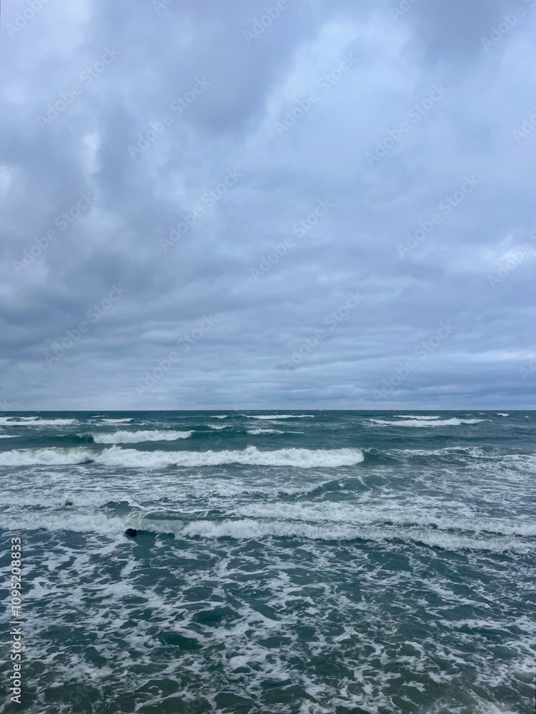 Cloudy seascape, seashore waves, natural sea horizon, cloudy sky Cloudy seascape, seashore waves, natural sea horizon, cloudy sky