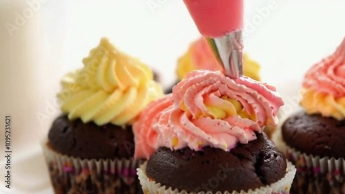 Close-Up Video of Vibrant Frosting Decoration on Chocolate Cupcakes in Warm Festive Lighting