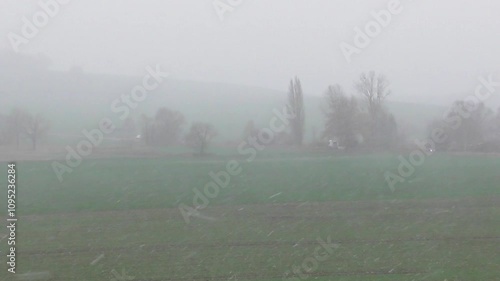 snow storm in a green valley in autumn photo