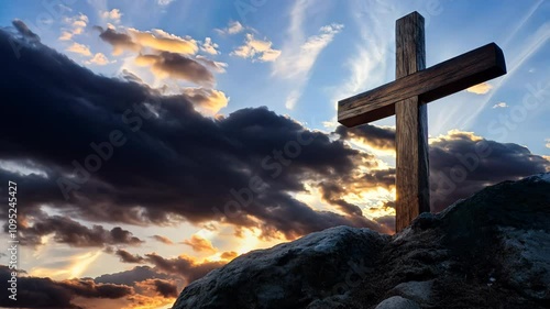 Big wooden cross on a mountain top. Religious background with copy space for text/title. Spiritual sacred catholic church symbol at sunset colorful clouds. Christianity motion template/mockup.