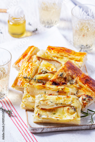 Obraz na płótnie Puff pastry pie with cheese, pears, nuts and honey, served with champagne. w salonie