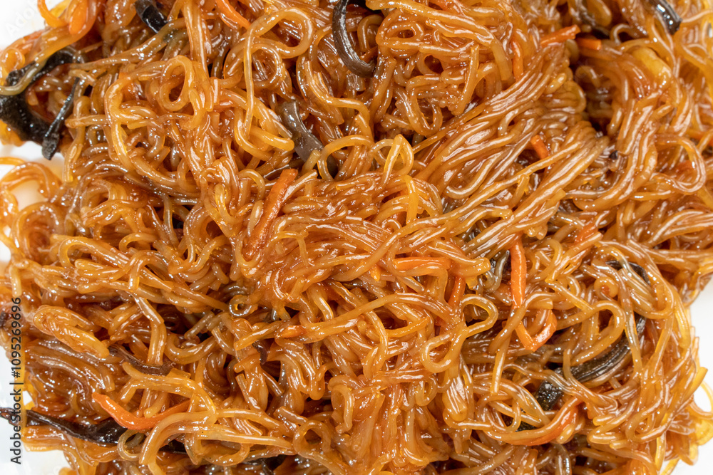 Funchoza, Chinese noodles with mushrooms and vegetables on a wooden background. Food concept. Chinese food. Funchoza, Chinese noodles with mushrooms and vegetables on a wooden background. Food concept. Chinese food.