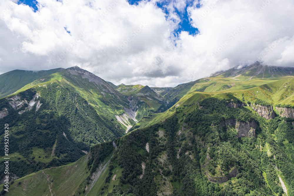 Caucasian mountains near Gudauri village. Kazbegi mountain behind the clouds. Georgia