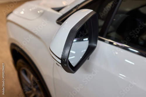 An elegant closeup shot of a sleek car side mirror showcasing its design and details