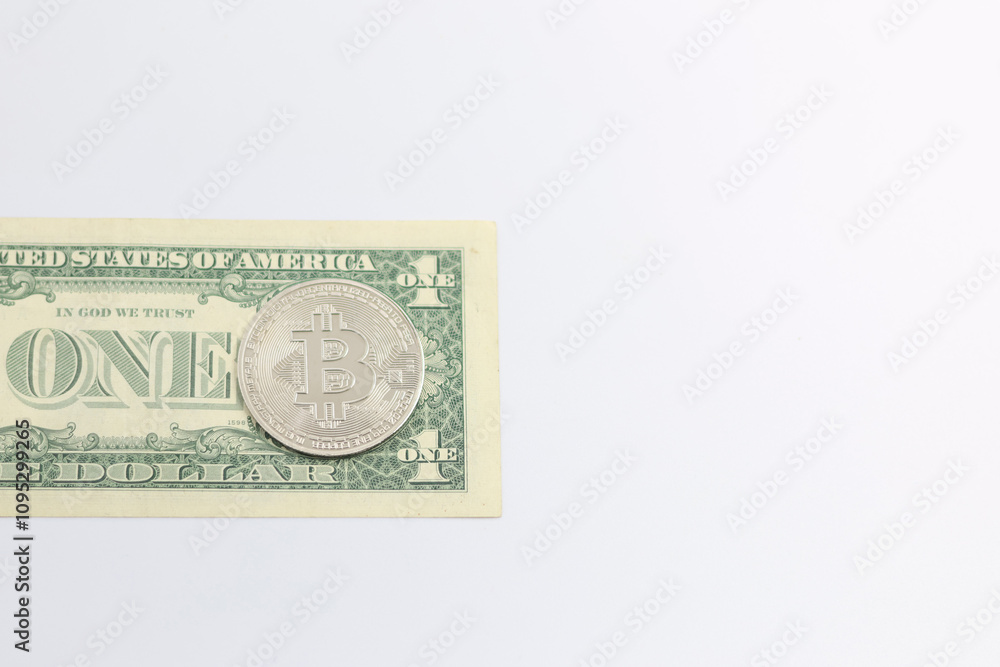 A bitcoin coin on an American dollar bill. A bitcoin coin on an American dollar bill.