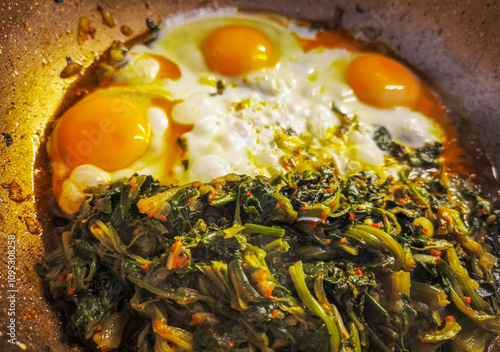 Healthy omelet with spinach. Eggs with spinach in a frying pan.