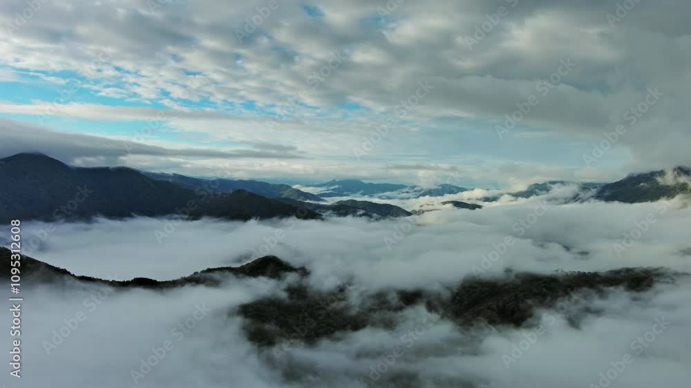 Flying between the clouds. Aerial view of clouds and mountains at sunrise, panorama 4k Flying between the clouds. Aerial view of clouds and mountains at sunrise, panorama 4k