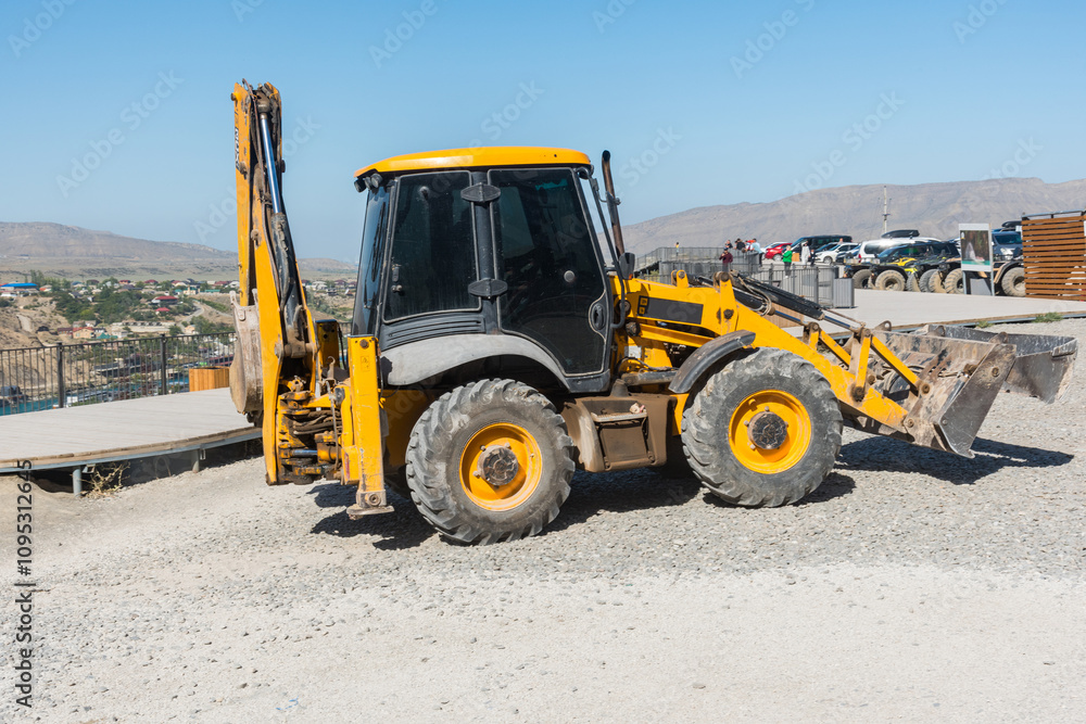 wheeled tractor bulldozer in a mountainous tourist area wheeled tractor bulldozer in a mountainous tourist area