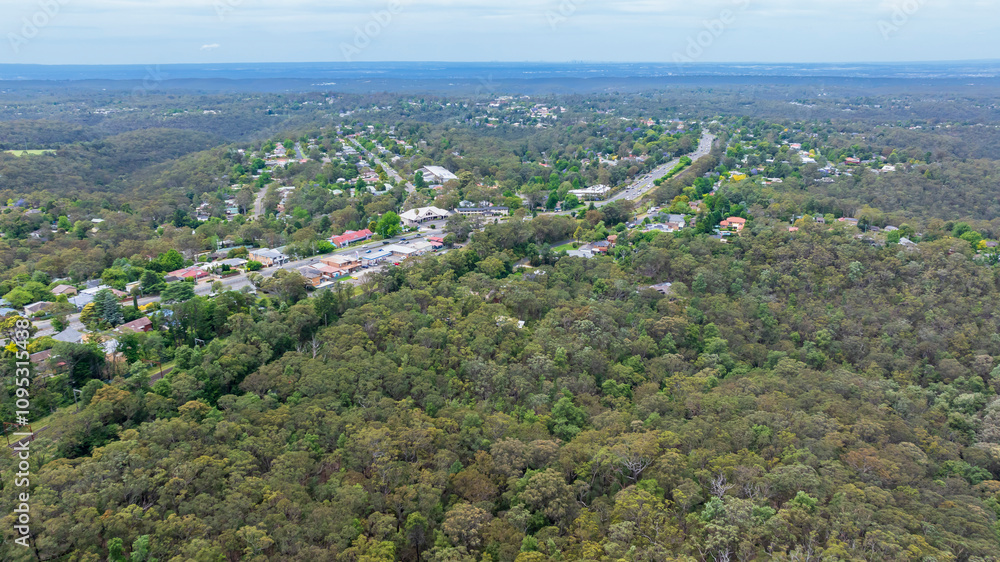 Drone aerial photograph of the town of Faulconbridge located along the Great Western Highway and surrounded by lush green forest in the Blue Mountains in New South Wales, Australia. Drone aerial photograph of the town of Faulconbridge located along the Great Western Highway and surrounded by lush green forest in the Blue Mountains in New South Wales, Australia.