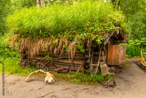 grass and flowers on a trapper cabin photo