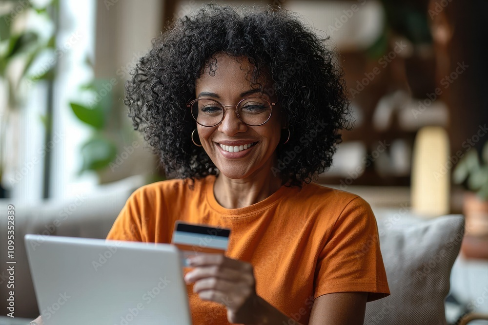Middle-aged woman smiling while shopping online with credit card at home Middle-aged woman smiling while shopping online with credit card at home