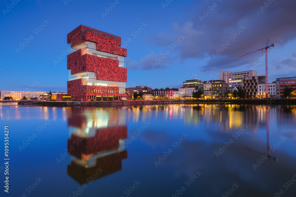 MAS museum, Antwerp, Belgium. Cityscape during sunset. Reflection on the water surface. MAS museum near the water in the bay. Architecture of the Belgium. Travel photography.