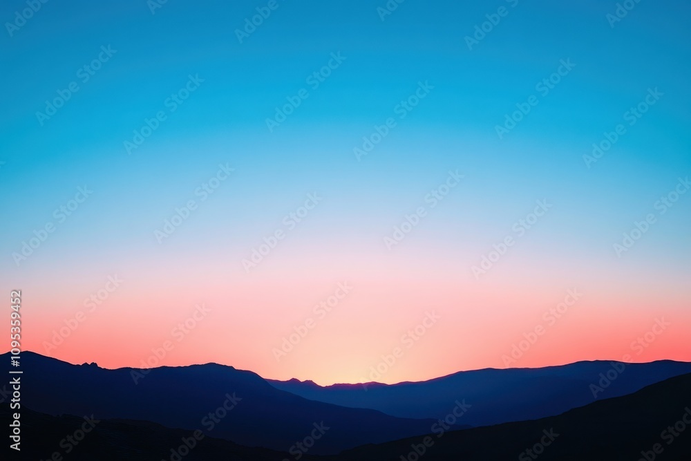Sunset over mountain range with vibrant blue and pink sky during twilight hours Sunset over mountain range with vibrant blue and pink sky during twilight hours