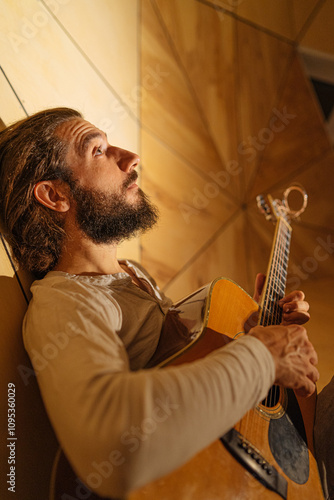 long hair man musician travel guitarist guitar with objects in the hands photo