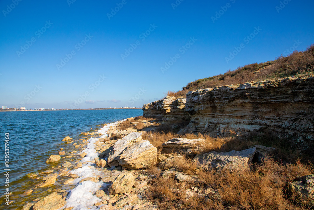 White foam on the lake shore White foam on the lake shore