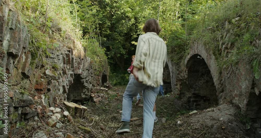 Three friends run past the ruins of a historic building. A sunny summer day. Three friends run past the ruins of a historic building. A sunny summer day.