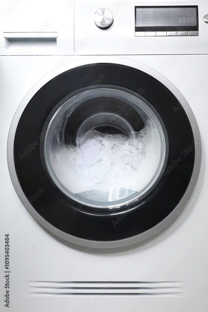Washing machine with clothes and suds as background, closeup Washing machine with clothes and suds as background, closeup