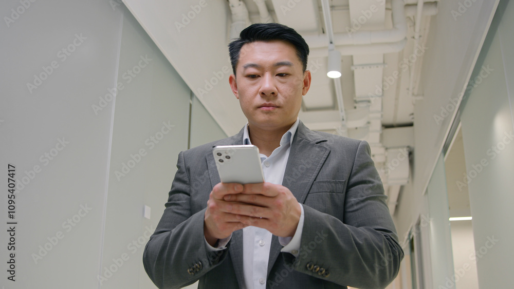 Asian adult 40s senior middle-aged businessman browsing smartphone app mobile chatting online business networking data connections chinese korean japanese man male employer boss using phone internet Asian adult 40s senior middle-aged businessman browsing smartphone app mobile chatting online business networking data connections chinese korean japanese man male employer boss using phone internet