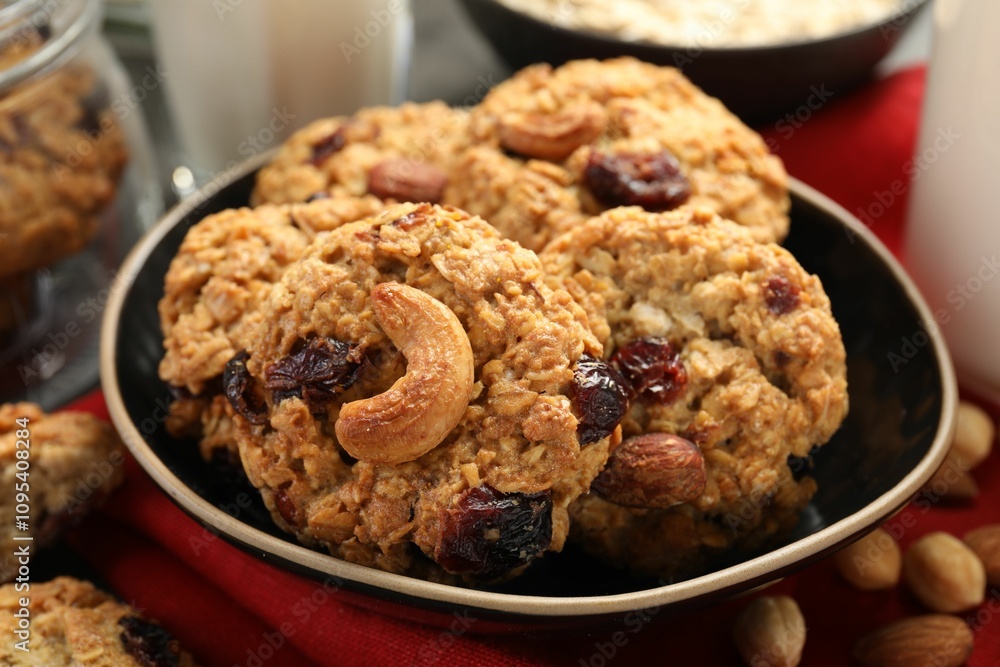 Delicious oatmeal cookies with raisins and nuts on table, closeup Delicious oatmeal cookies with raisins and nuts on table, closeup