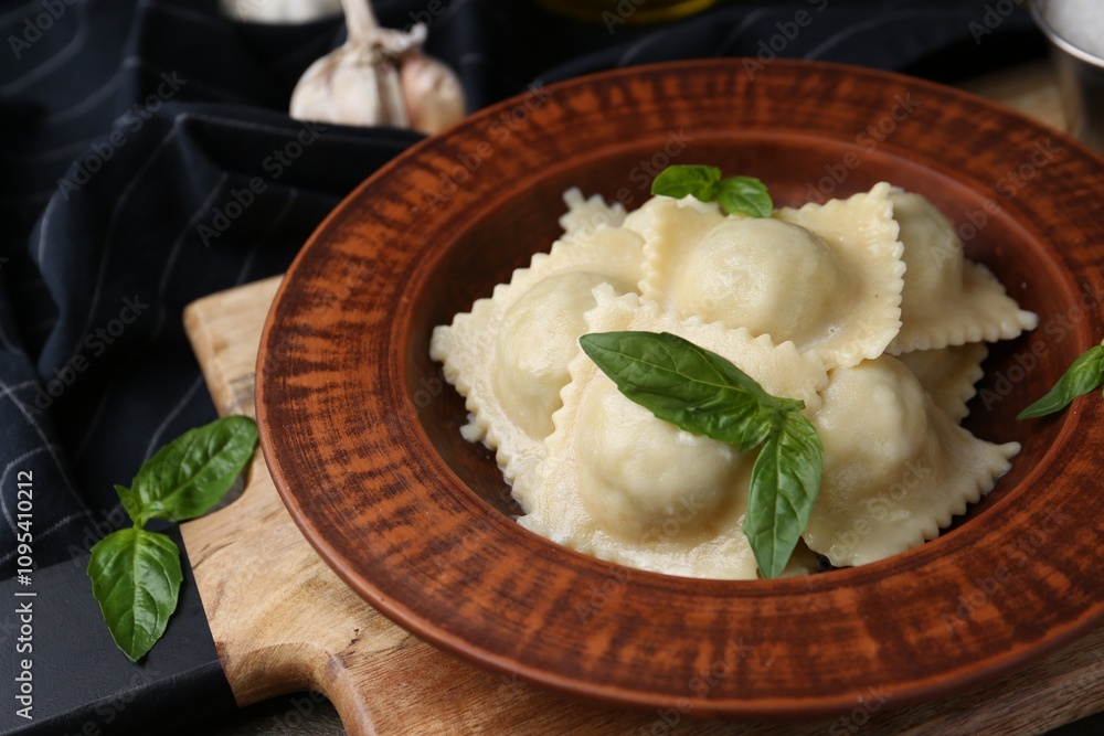 Delicious ravioli with cheese and basil served on wooden table, closeup Delicious ravioli with cheese and basil served on wooden table, closeup