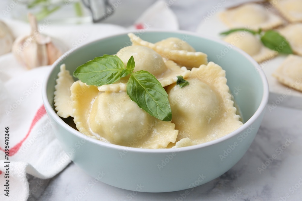 Delicious ravioli with cheese and basil served on white marble table, closeup Delicious ravioli with cheese and basil served on white marble table, closeup