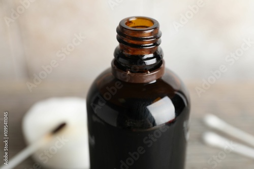 Bottle of topical iodine on blurred background, closeup photo