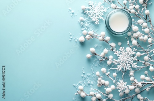 Decorative winter scene featuring snowflakes and a candle on a light blue bac...