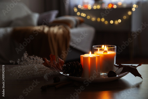 autumn and winter home decor with burning candles
