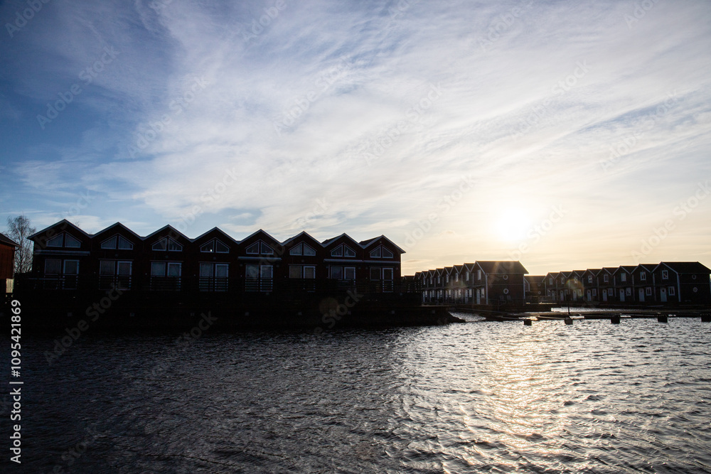 Harbor by the lake, landscape shot in autumn. Holiday village and harbor on the water in Sunnana Hamn in Sweden Harbor by the lake, landscape shot in autumn. Holiday village and harbor on the water in Sunnana Hamn in Sweden
