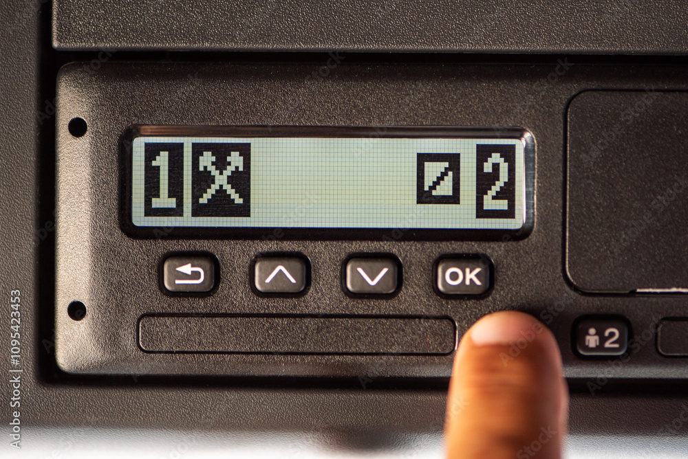 Digital tachograph display on a truck showing the first driver punching other jobs and the second driver on call. Digital tachograph display on a truck showing the first driver punching other jobs and the second driver on call.