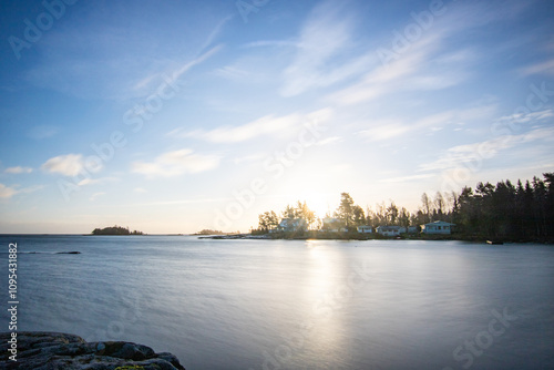 Shore of a lake at sunrise. Landscape shot in the Narur in the morning. Forests lake and water at the beginning of winter or in autumn. Sweden, Scandinavia