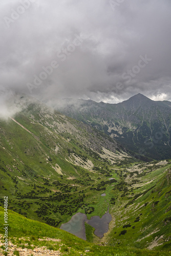 Obraz na płótnie clouds over the mountains, view of the western Tatras in summer under a cloudy sky w salonie