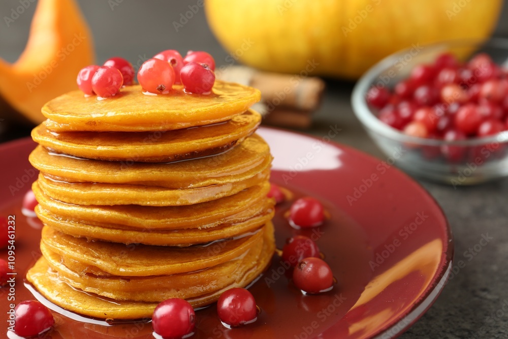 Tasty pumpkin pancakes with cranberries and honey on table, closeup Tasty pumpkin pancakes with cranberries and honey on table, closeup