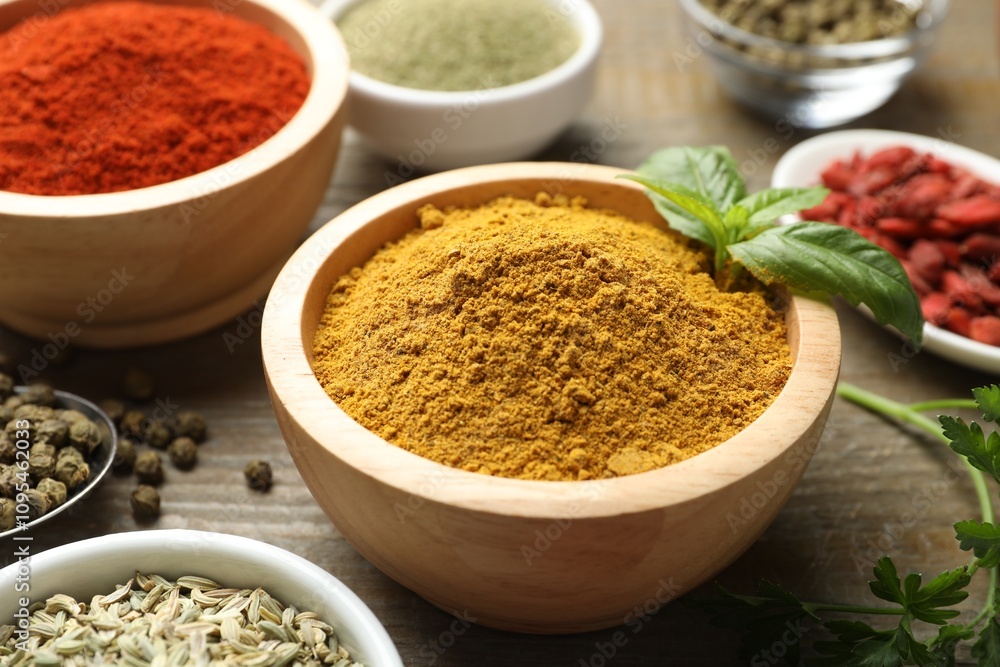 Different aromatic spices on wooden table, closeup Different aromatic spices on wooden table, closeup