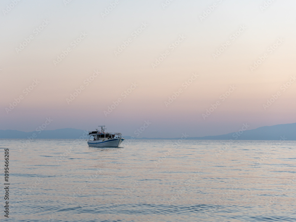 A serene evening unfolds as a fishing boat quietly drifts across calm waters. Soft hues of dusk reflect on the surface, highlighting the peacefulness of the moment. A serene evening unfolds as a fishing boat quietly drifts across calm waters. Soft hues of dusk reflect on the surface, highlighting the peacefulness of the moment.