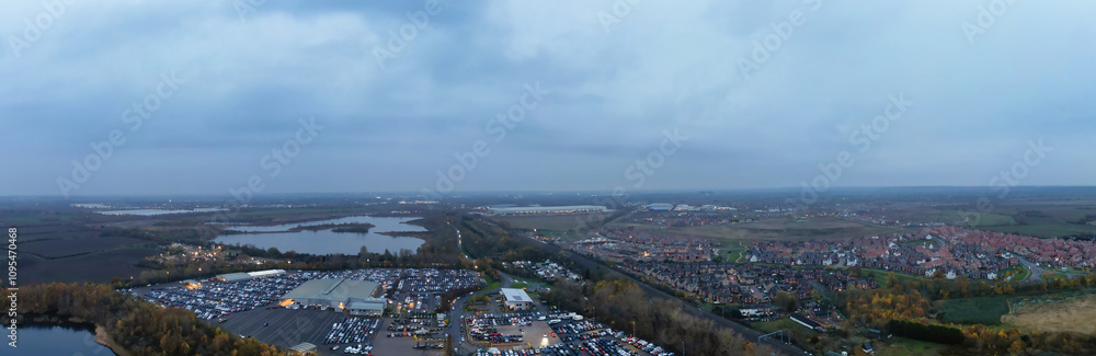 Aerial Panoramic View of Car Auctions Massive Car Parking Lot at Kempston Village of Bedford England United Kingdom. High Angle Footage Captured During Cloudy Evening on November 18th, 2024 Aerial Panoramic View of Car Auctions Massive Car Parking Lot at Kempston Village of Bedford England United Kingdom. High Angle Footage Captured During Cloudy Evening on November 18th, 2024