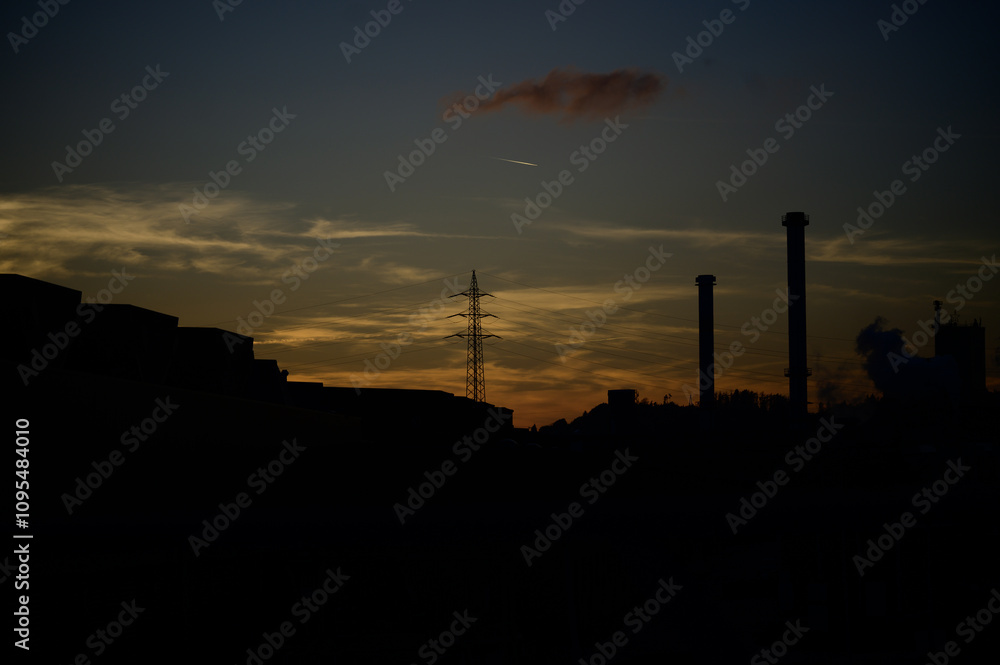 Naklejka premium sunset over an industrial city
