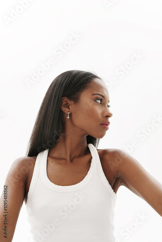 Confident young dark skinned woman looking away. Vertical.