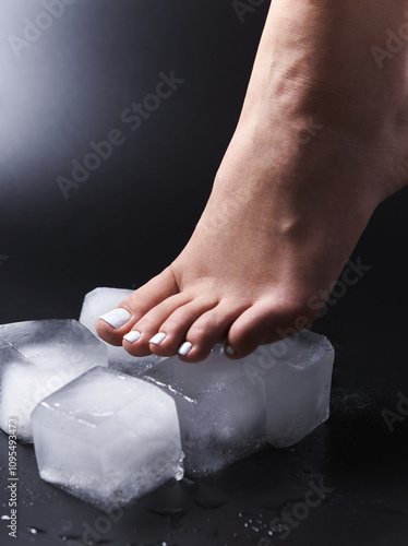 Beautiful female foot with pedicure on black background 