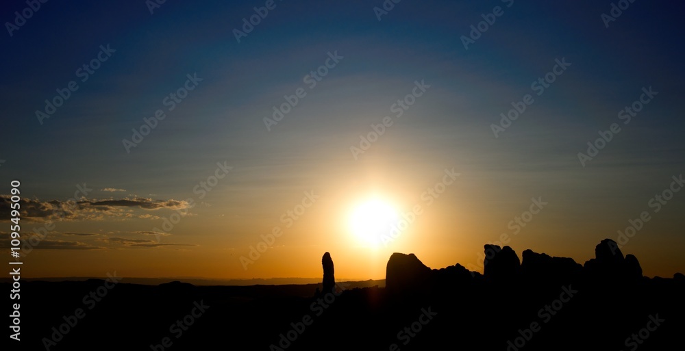 Majestic wide shot of sun setting below southern Utah desert Majestic wide shot of sun setting below southern Utah desert