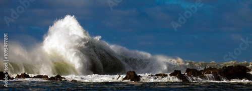 Crashing and misty waves over rocky island patch