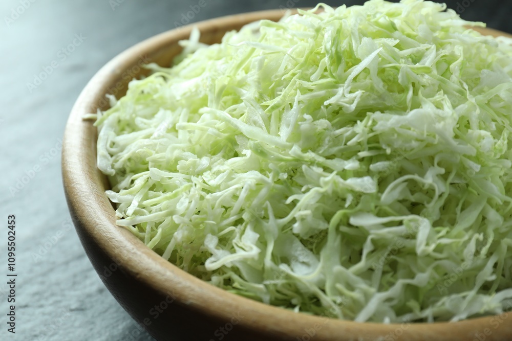 Fresh shredded cabbage on black table, closeup Fresh shredded cabbage on black table, closeup
